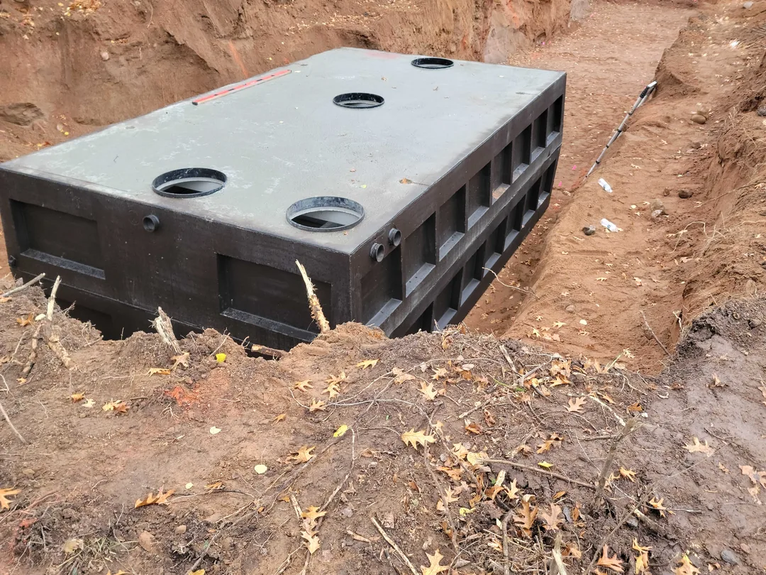 New septic tank set in an open excavation, septic system installation