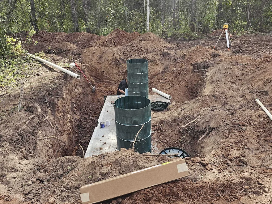 Septic tank with green risers in an open excavation, septic system installation